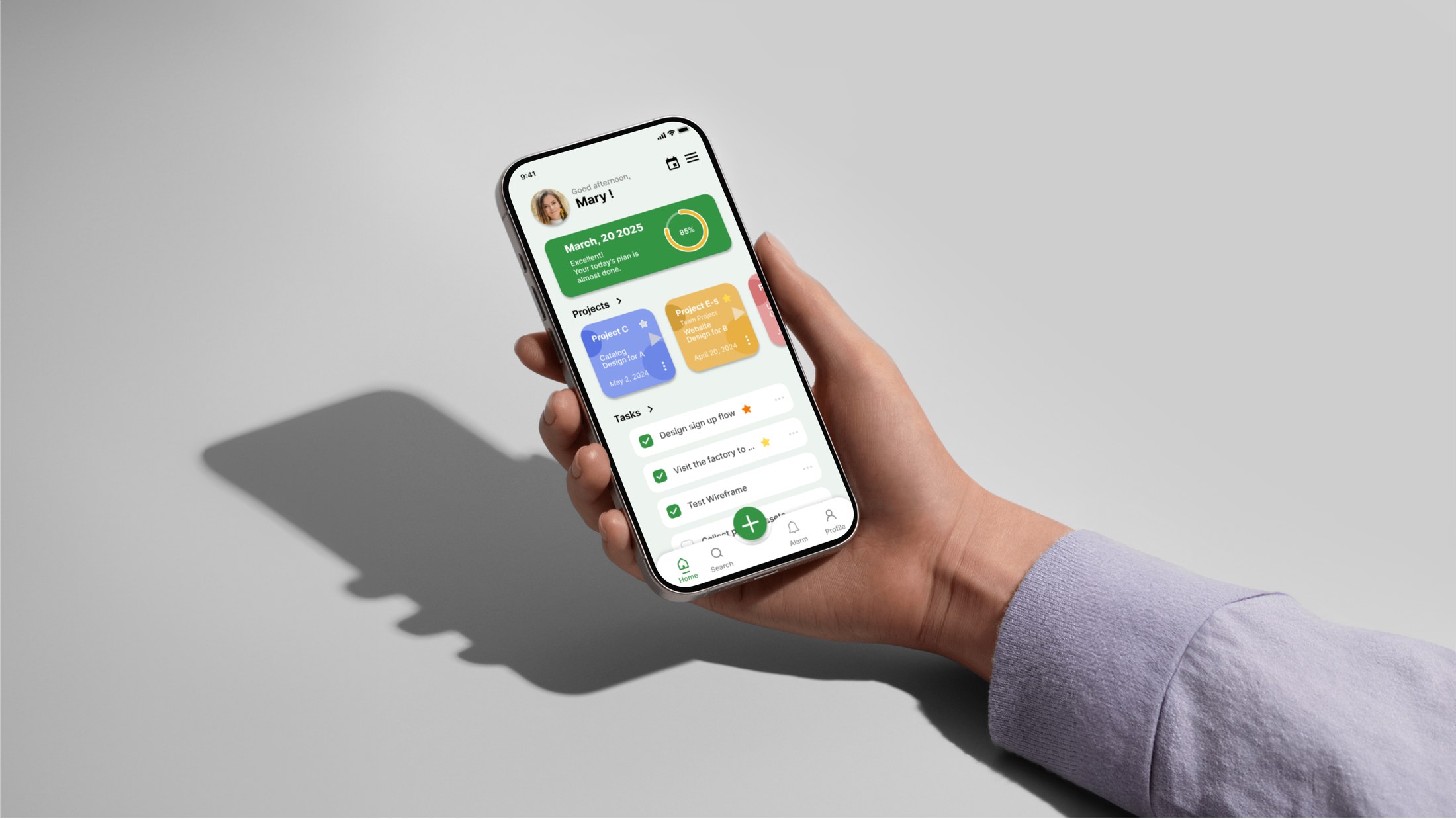 TTASK — hand-held hero mockup of the scheduler home screen